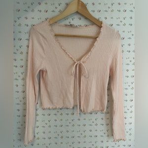 A baby pink tie up cardigan in size small